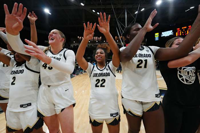 Colorado Buffaloes guard Tameiya Sadler (2) and forward Charlotte Whittaker (45) and guard Shelomi Sanders (22) and center Aaronette Vonleh (21) celebrate defeating the Oregon Ducks at CU Events Center